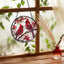 Atrapasoles ventana diseño pájaro rojo decoración